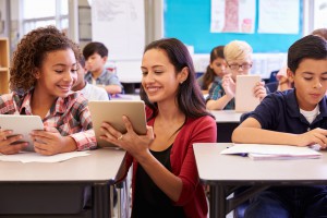 Teacher helping student.